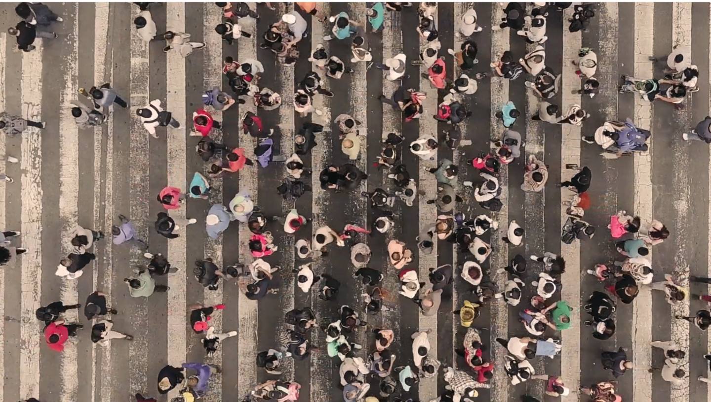 Aerial view of a crowded crosswalk, the real people whose lived experience makes real-world evidence possible